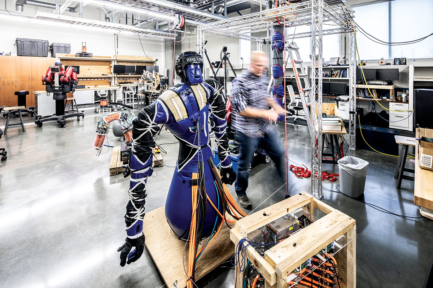 A grad student works on a inflatable robot in a BYU lab.
