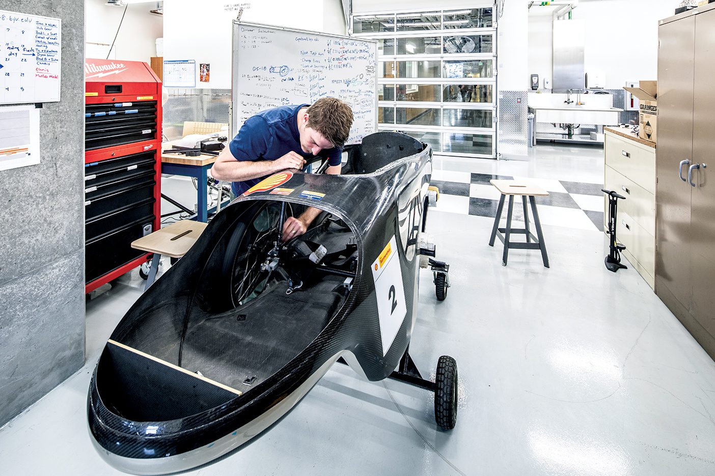 A student works on a supermileage vehicle in BYU's new Engineering Building.