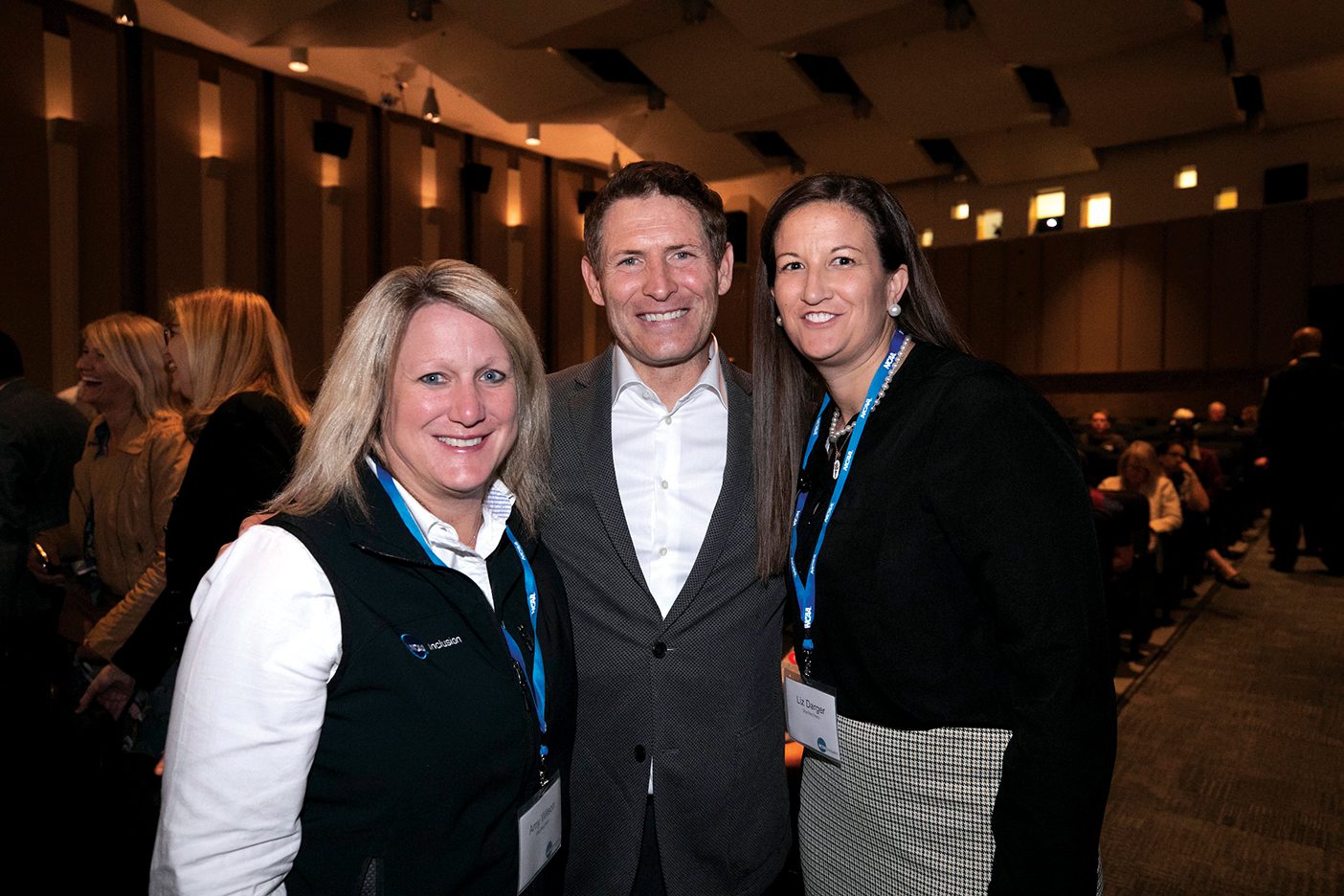 Steve Young stands in between Amy Wilson and Liz Darger at a BYU-hosted NCAA Common Ground event.