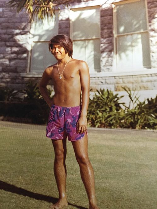 A teenaged Stacy Taniguchi is pictured his his swim trunks.