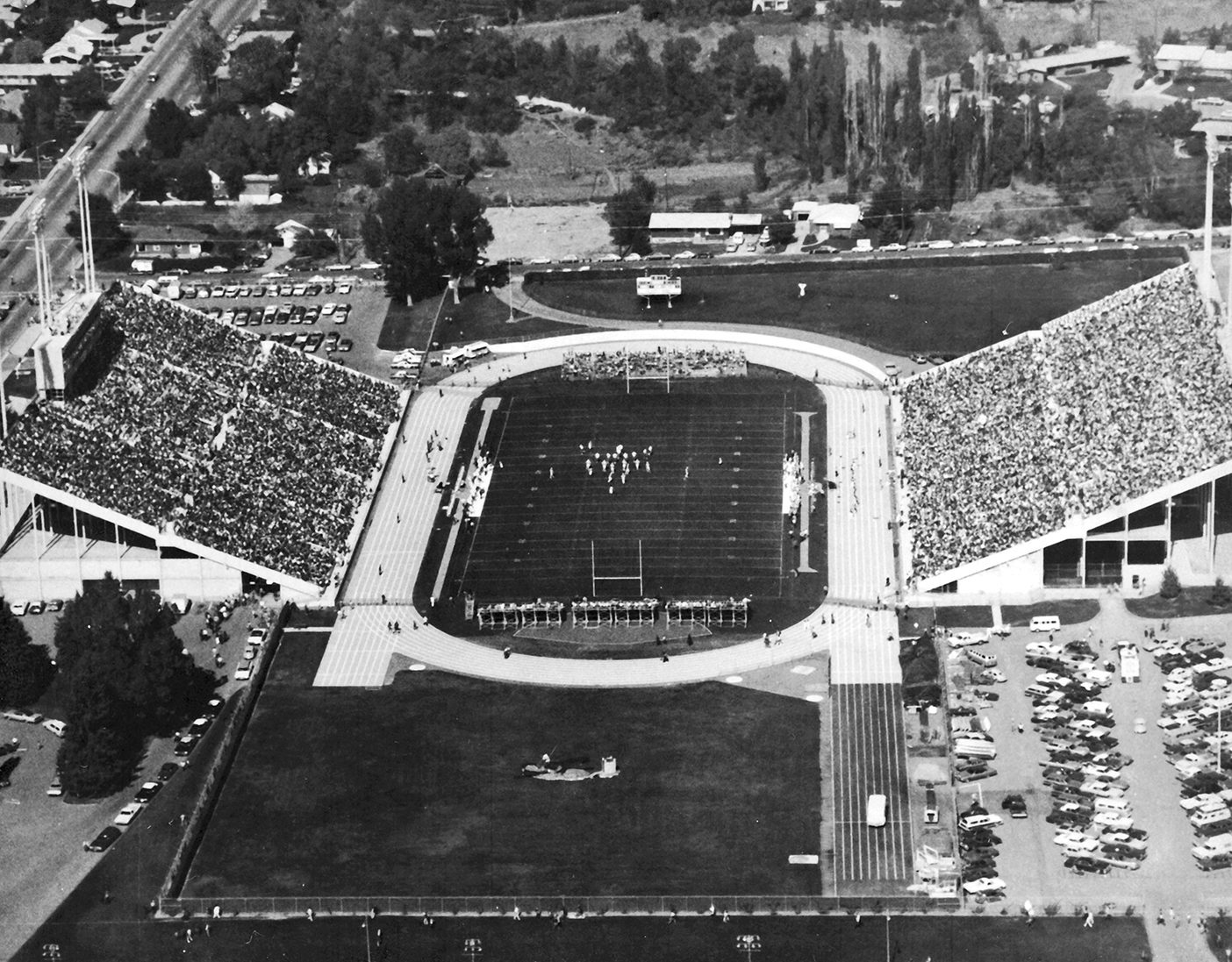 A black-and-white aerial picture of a packed Cougar Stadium during a football game in 1964.