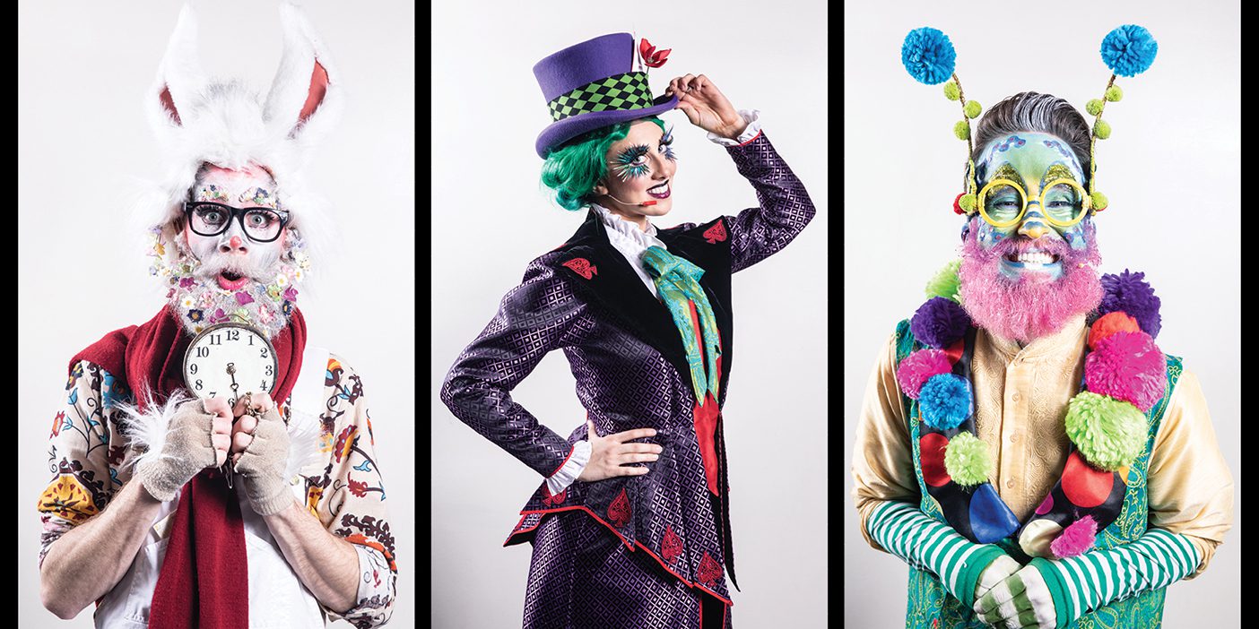 Three theater students, playing the White Rabbit, the Mad Hatter, and the Caterpillar, in costume for Wonderland.