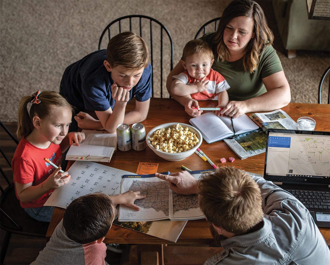 A family sitting around a table planning their summer.