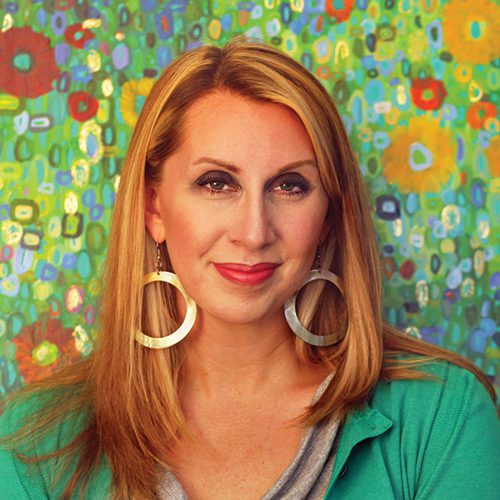 A headshot of Leslie Gradd against a fun painted floral backdrop.