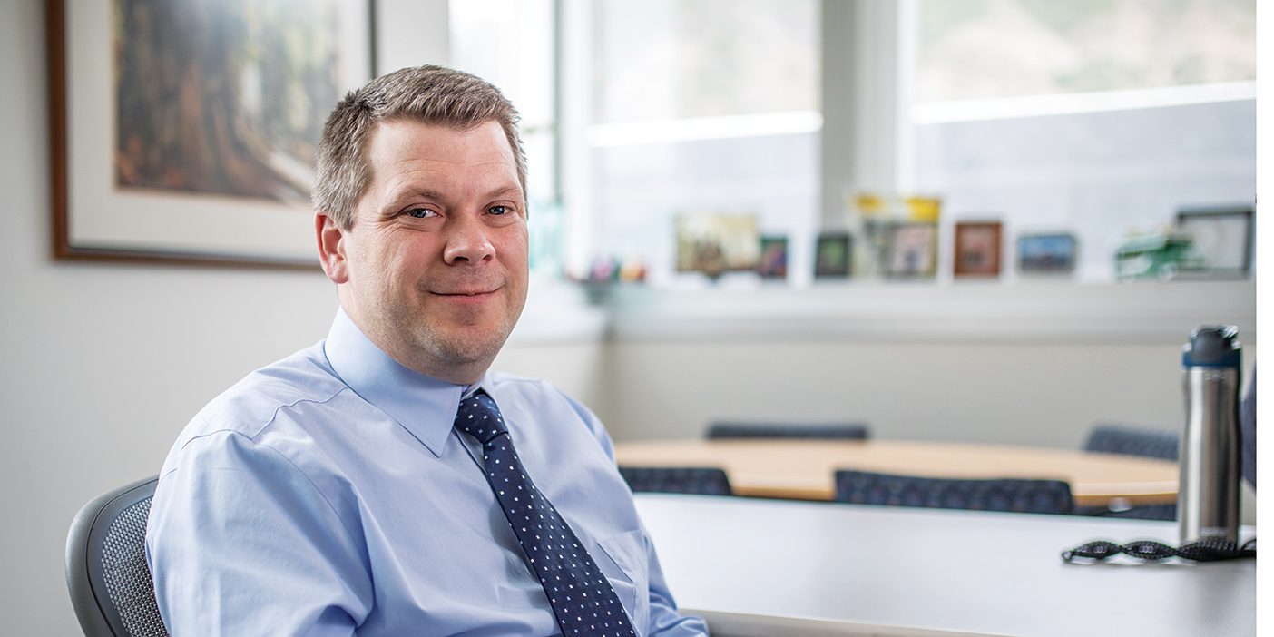 This image shows BYU Honor Code Office director Kevin Utt sitting in his office on BYU's campus.