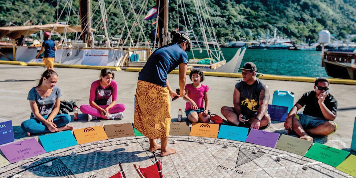 Linda Furuto teaches a group of young students while standing in a physical representation of the Hawaiian Star Compass.