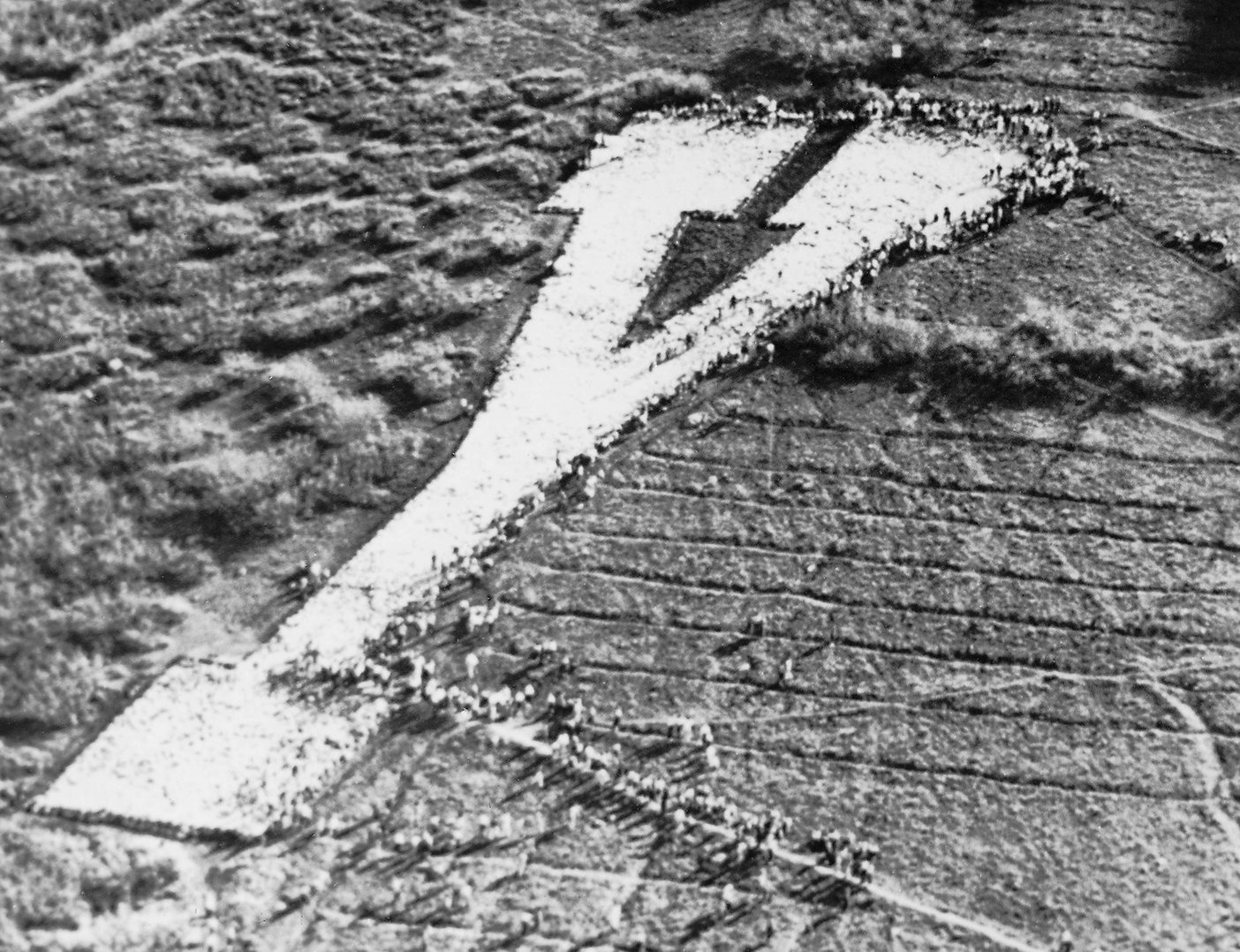 A historical image of students whitewashing the Y on the mountain above BYU.