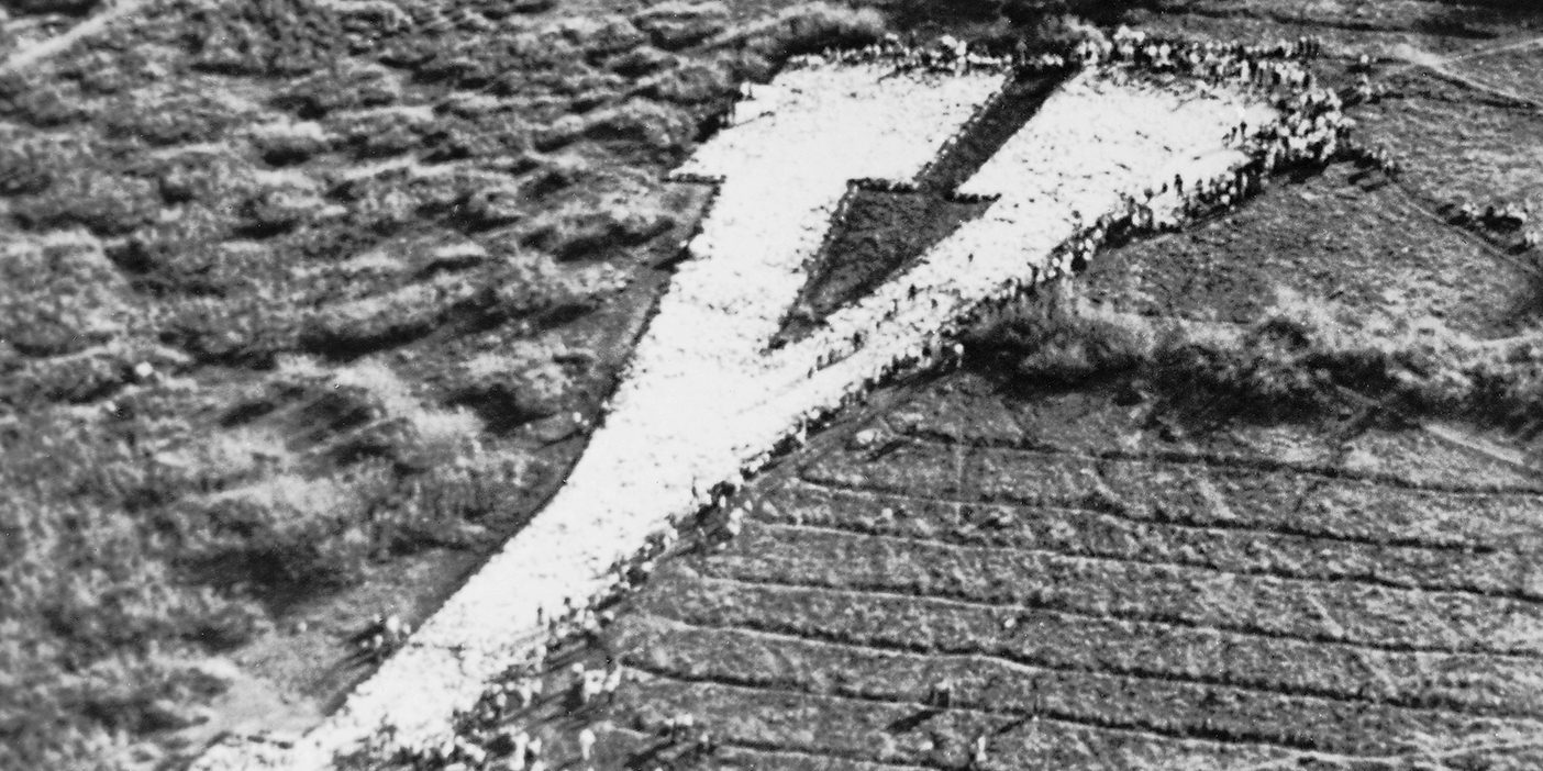 A historical image of students whitewashing the Y on the mountain above BYU.