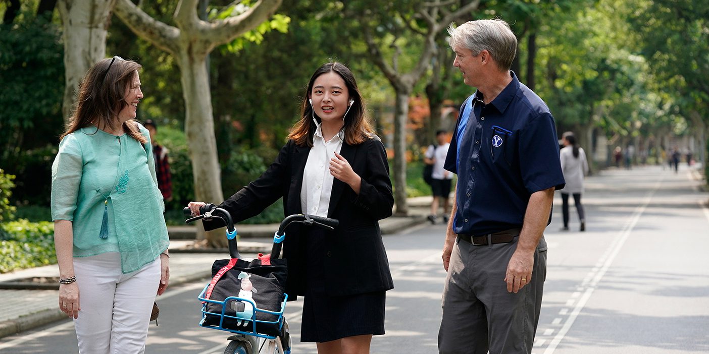 BYU China Teachers Angela and John Geddes visit with a young Chinese woman at Tongji University in Shanghai.