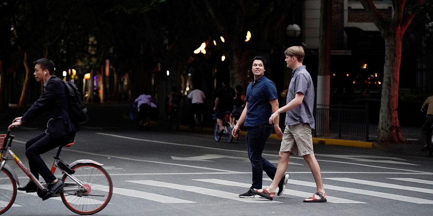 BYU students Danny Dawson and Nathan Jensen walk down a street in Shanghai, China.