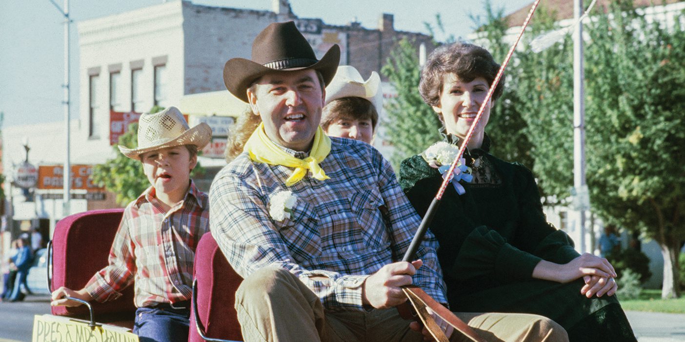 President Jeffrey R. Holland and his family ride in a wagon during the 1980 Homecoming parade.