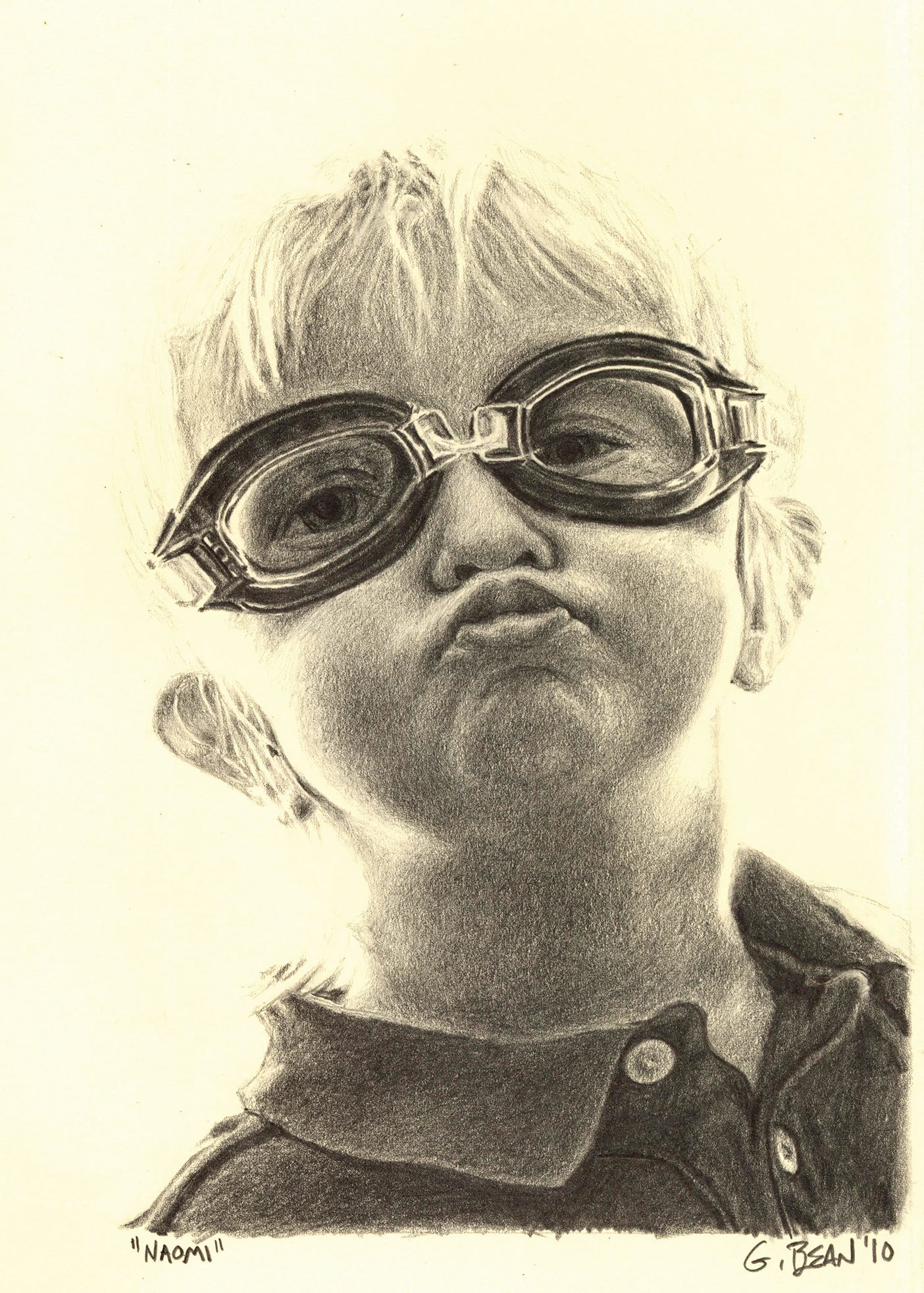 Greg Bean draws with graphite, a picture of a child wearing goggles and making a kissy face.