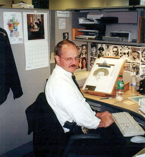 Greg Bean sits in his office working on a composite sketch.