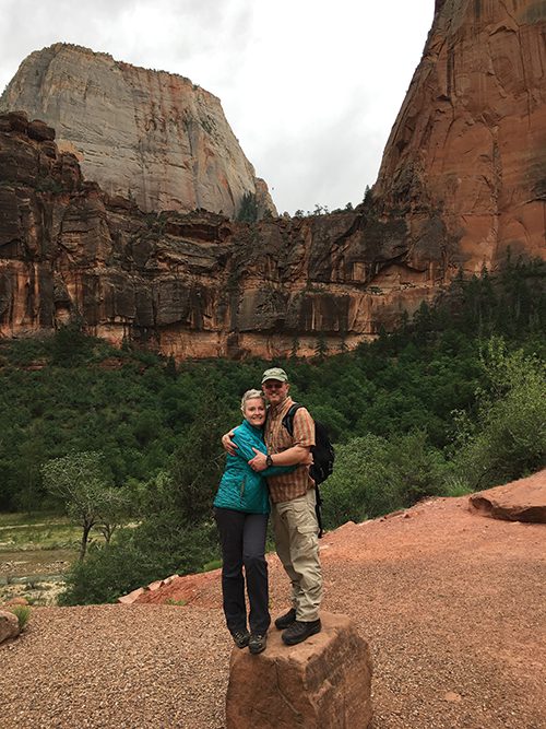 Greg and Jean Bean stand on top of a rock at Zion's National Park after their graduation from BYU.