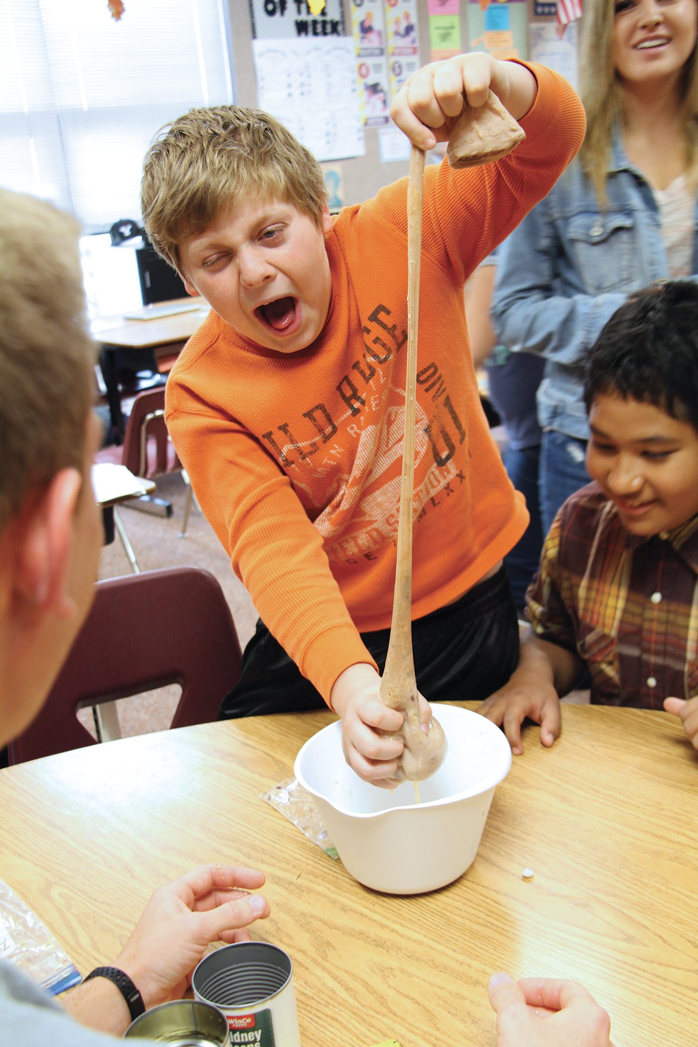 Fifth-grader Link Roper stretches a nylon sock filled with bananas in Anatomy Academy in his classroom.