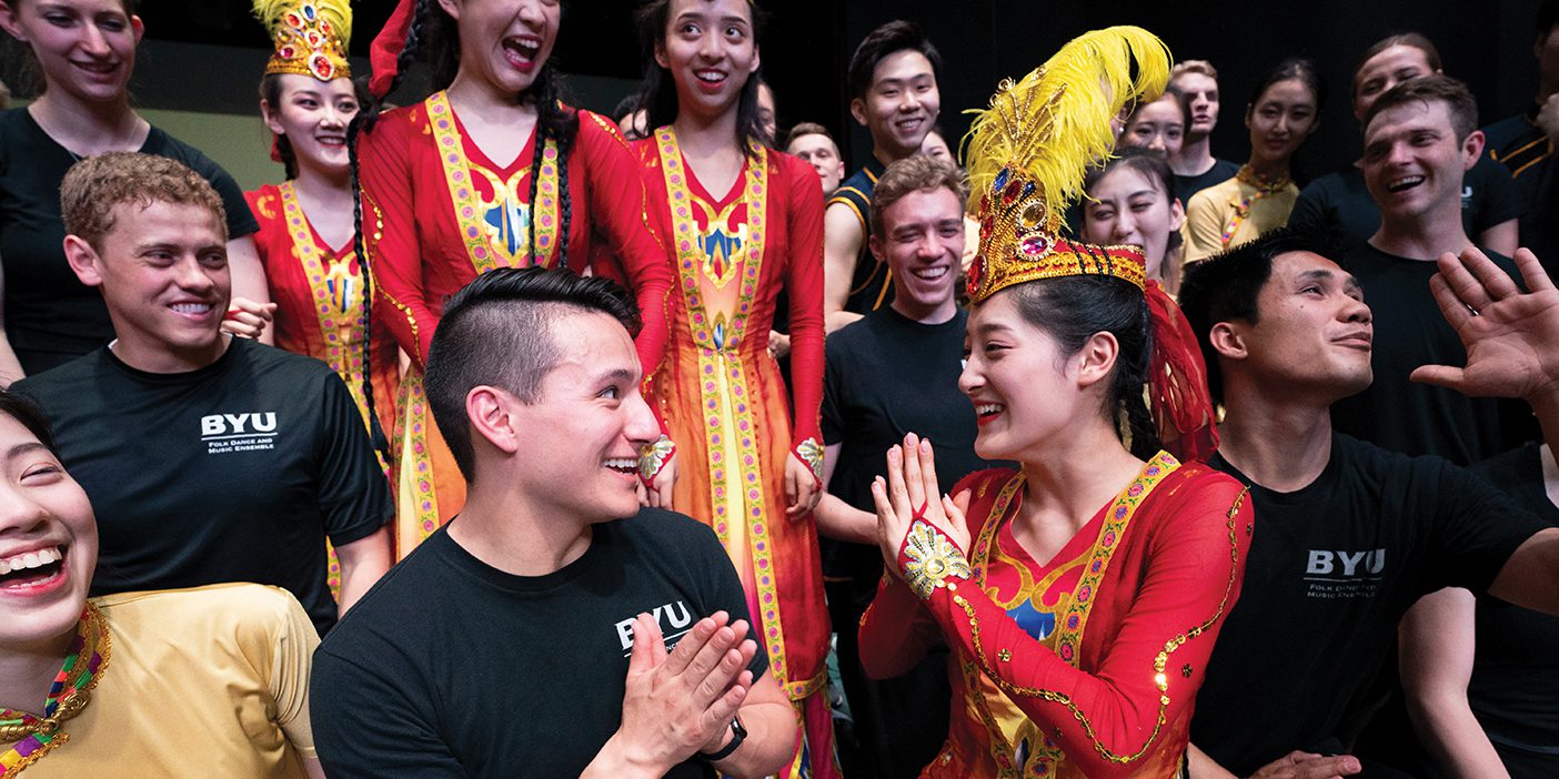 Isaiah Vela smiles at a performer from China's Minzu University.