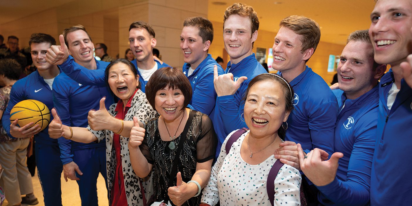 BYU dunk team members pose with a group of women in China.