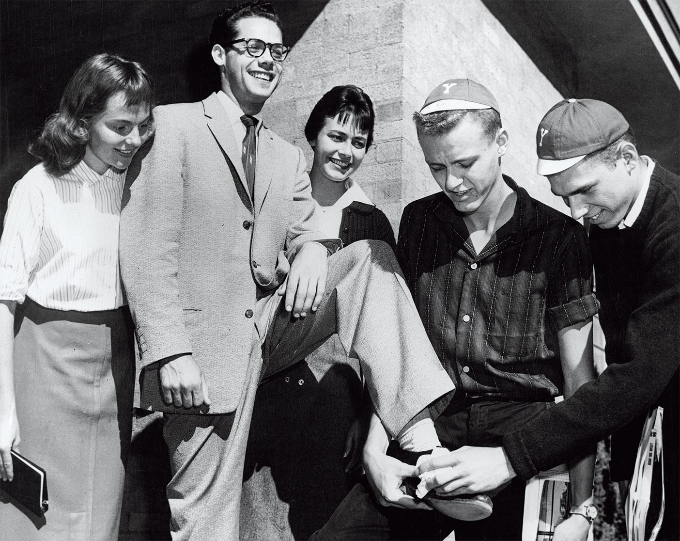 An archival photo from 1958 of BYU freshmen shining shoes.