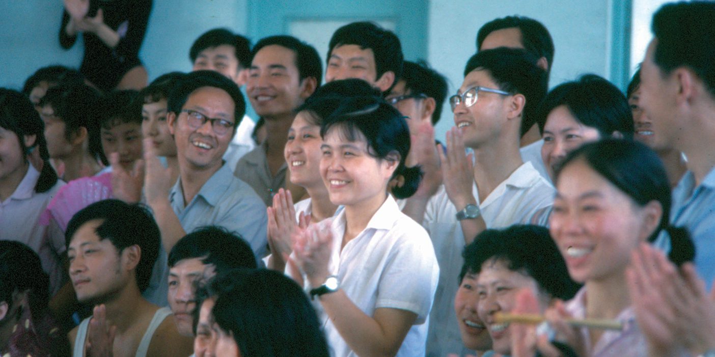 A crowd in China applauds