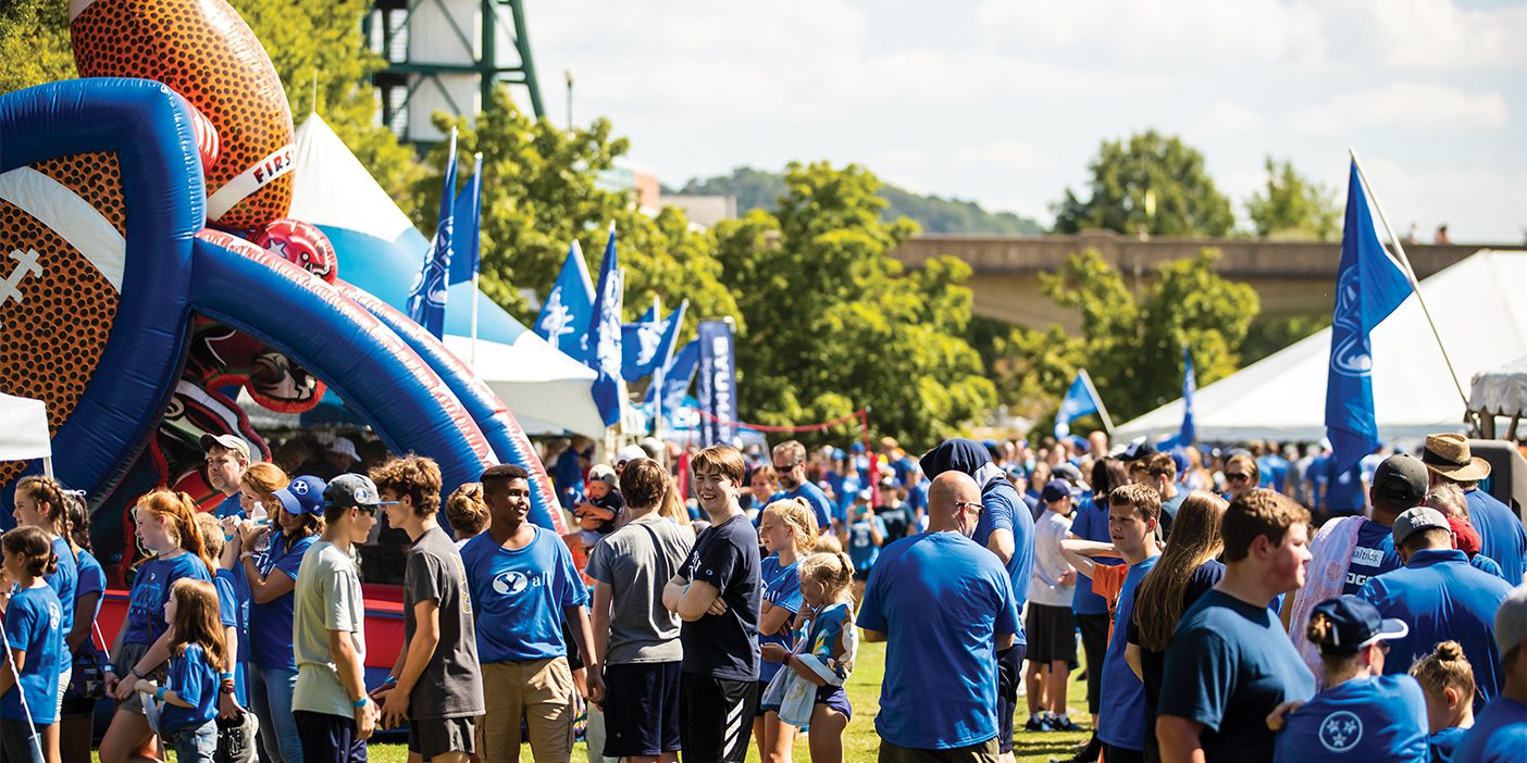 A large crowd of BYU fans tailgate outside of the football game in Tennessee to show support for the Cougars.
