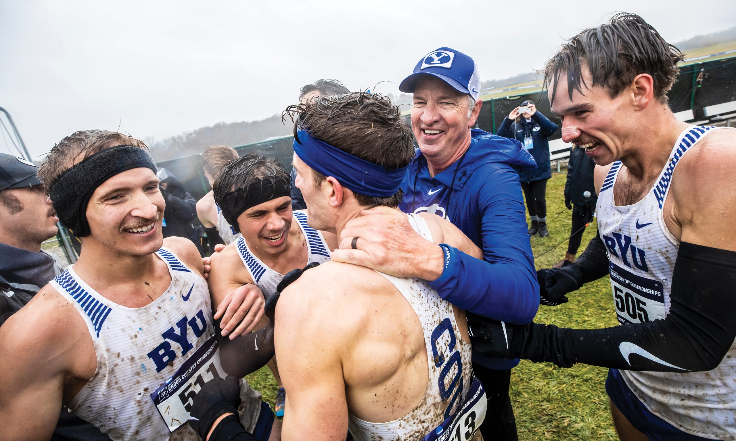 The 2019 BYU men's cross country team celebrates their victory after a wet and muddy national championship race.