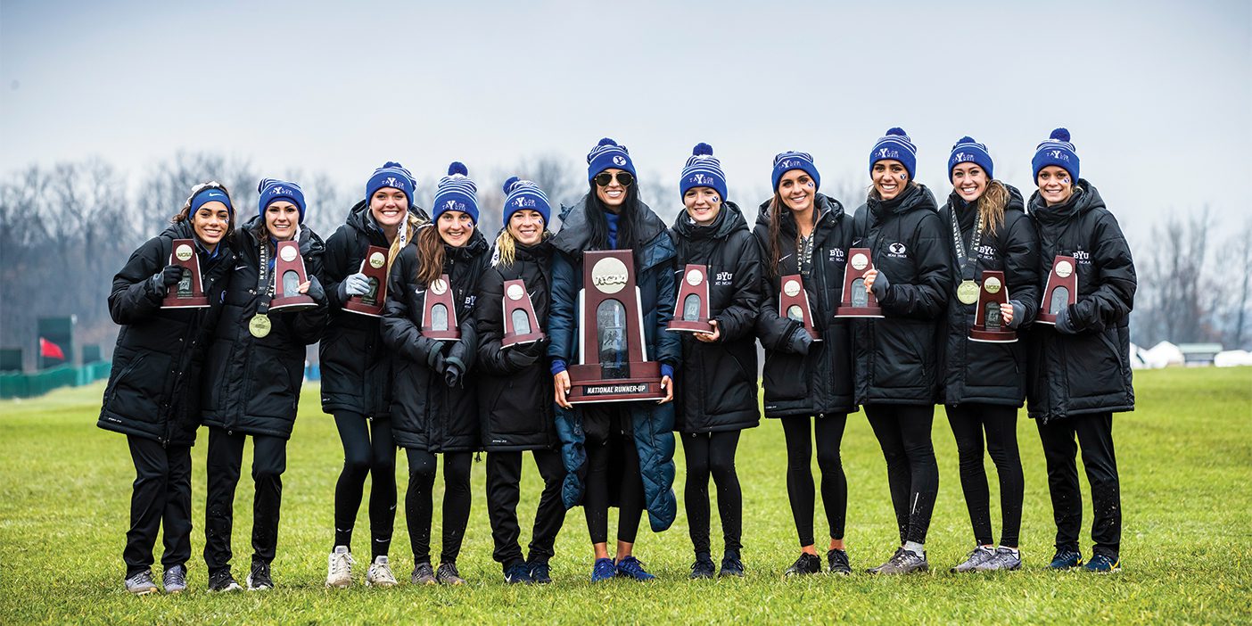 The BYU women's cross country team poses with their second-place trophy at the 2019 cross country national championships.