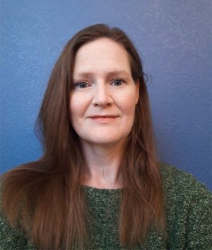 This headshot shows the author Rachel Bithell, a female with long brown hair.