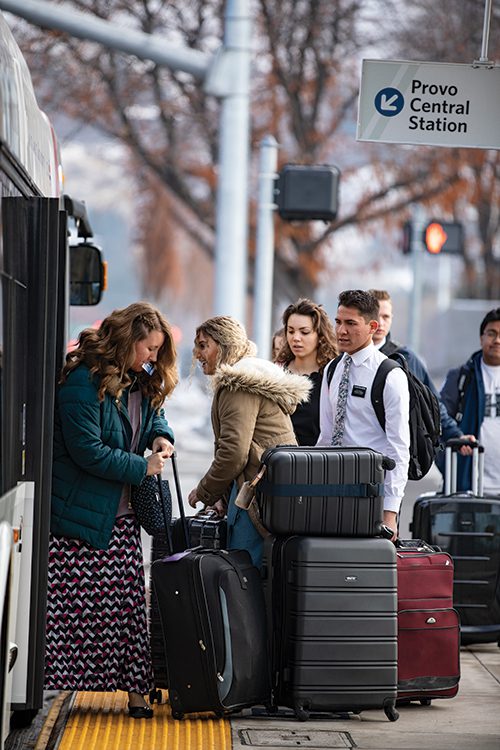 Latter-day Saint missionaries boarding a Utah Valley Express bus.