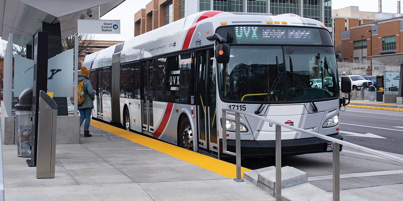 A bus stop in Provo, Utah, with a UVX bus there.