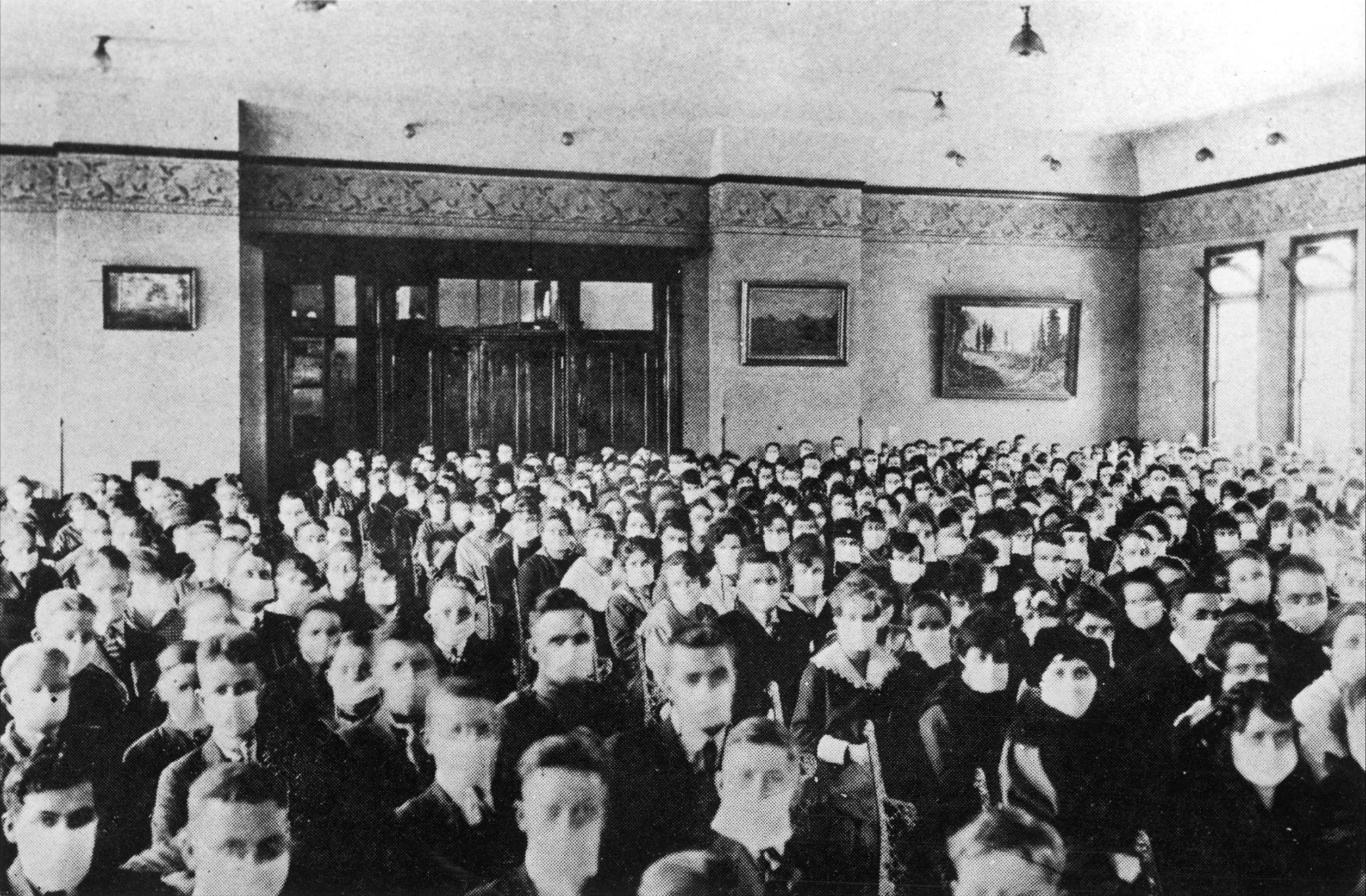 A Classroom of BYU students in 1919 wearing white medical masks