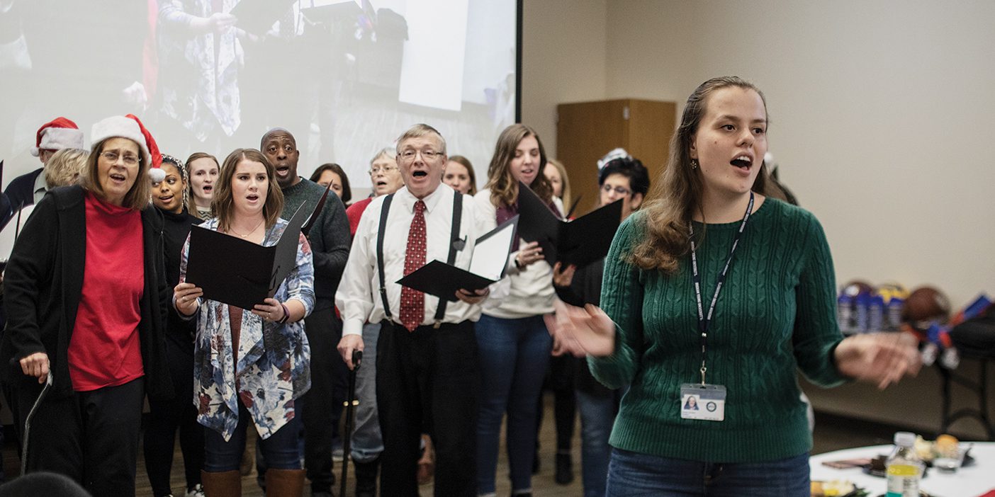 BYU grad student Amelia Jackson leads the Utah Valley Aphasia Choir singing a song.