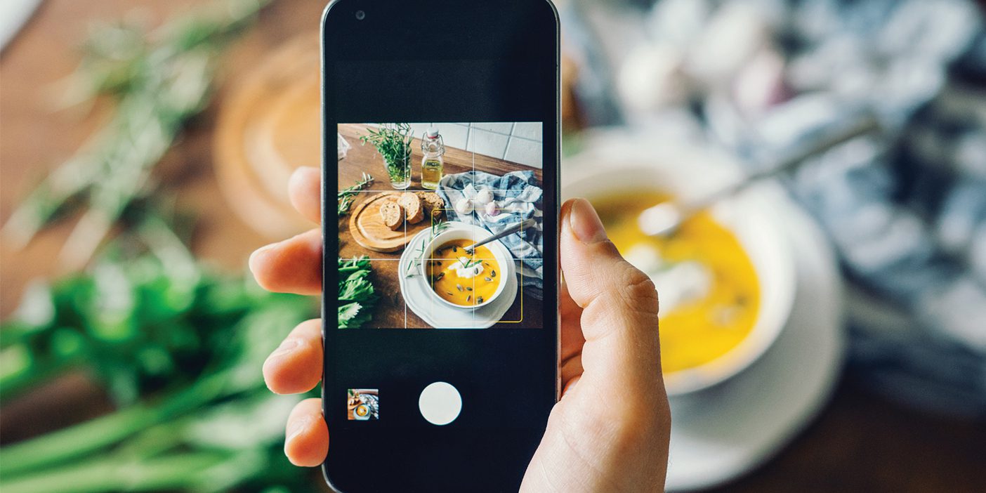 A phone taking a picture of a meal.