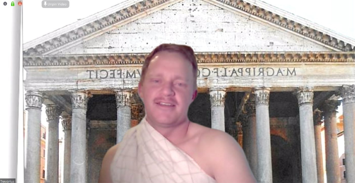 Trevor Lemmons dressed as a Roman in a toga on a Zoom call.