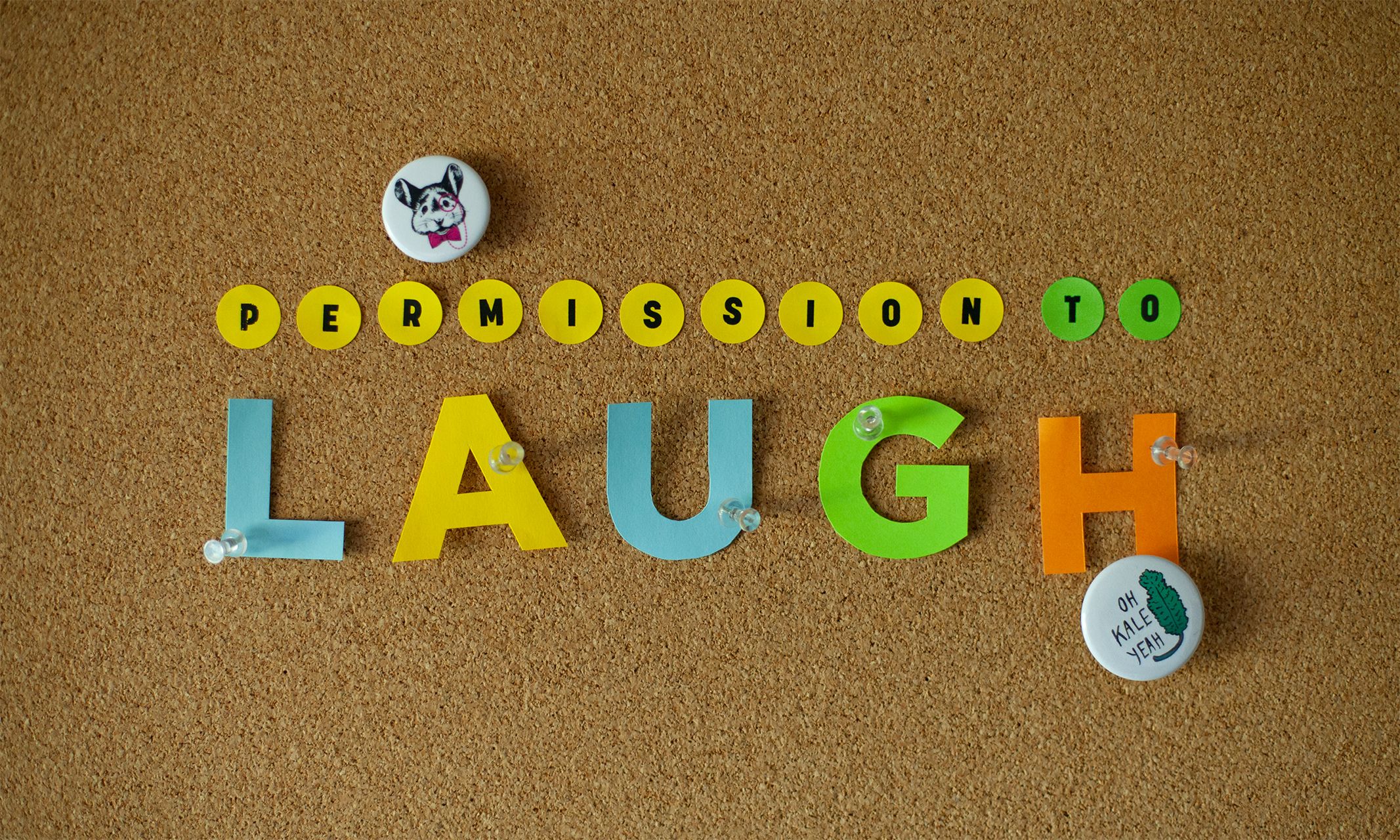 Article title "Permission to Laugh" on a cork board.