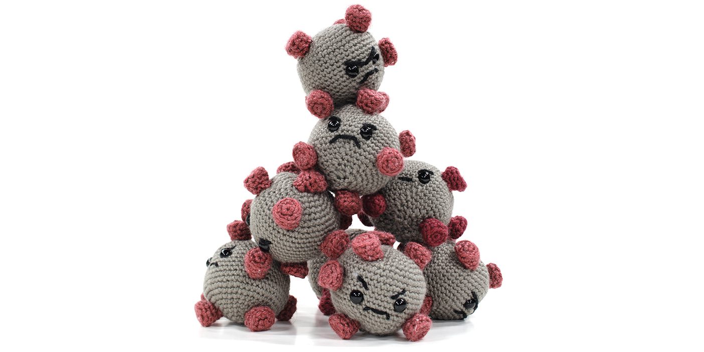Stuffed virus toys with varying upset faces built into a pyramid tower.