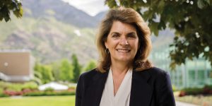 Karen Bybee smiles while on BYU campus with Y mountain in the background.