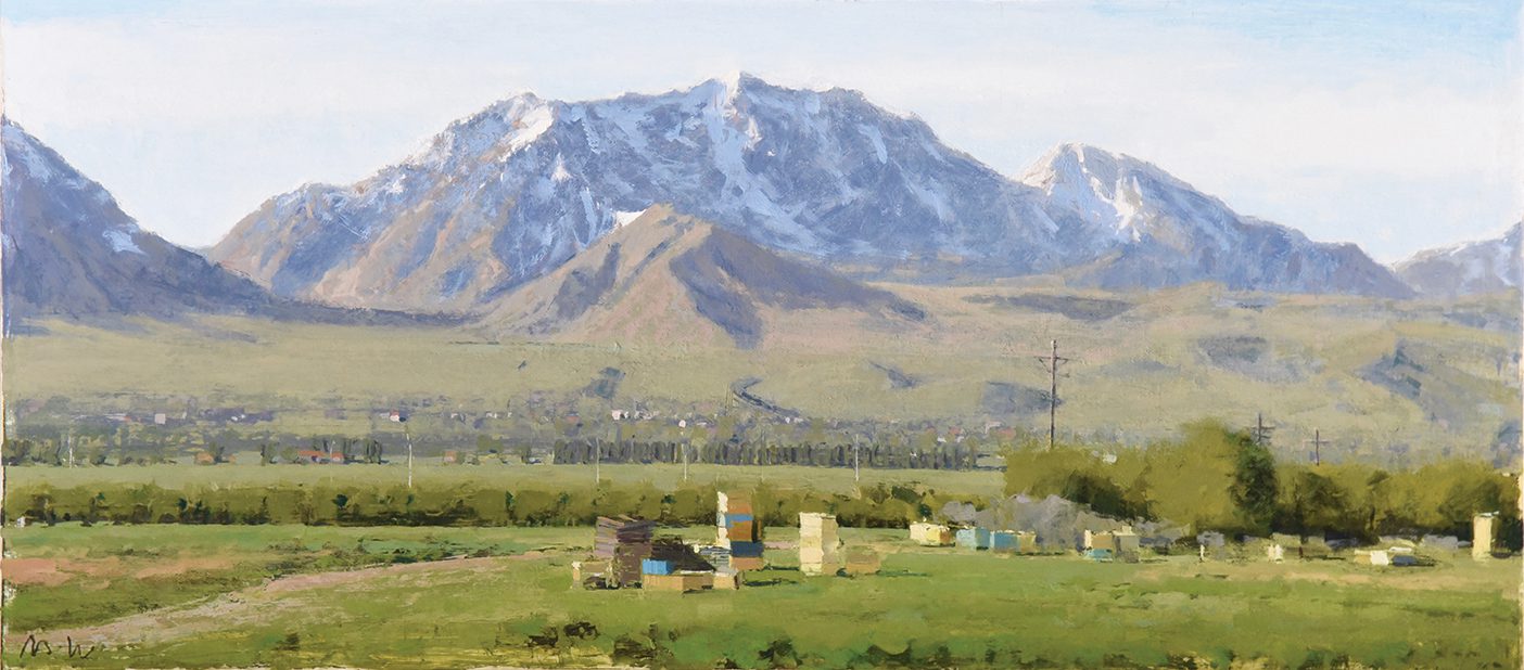 A mountain at the center of the canvas is lightly covered with snow at its peak, while the field below it is green and holds blue, yellow, and brown boxes or containers scattered across to the right. A town sits between the field and the mountain.