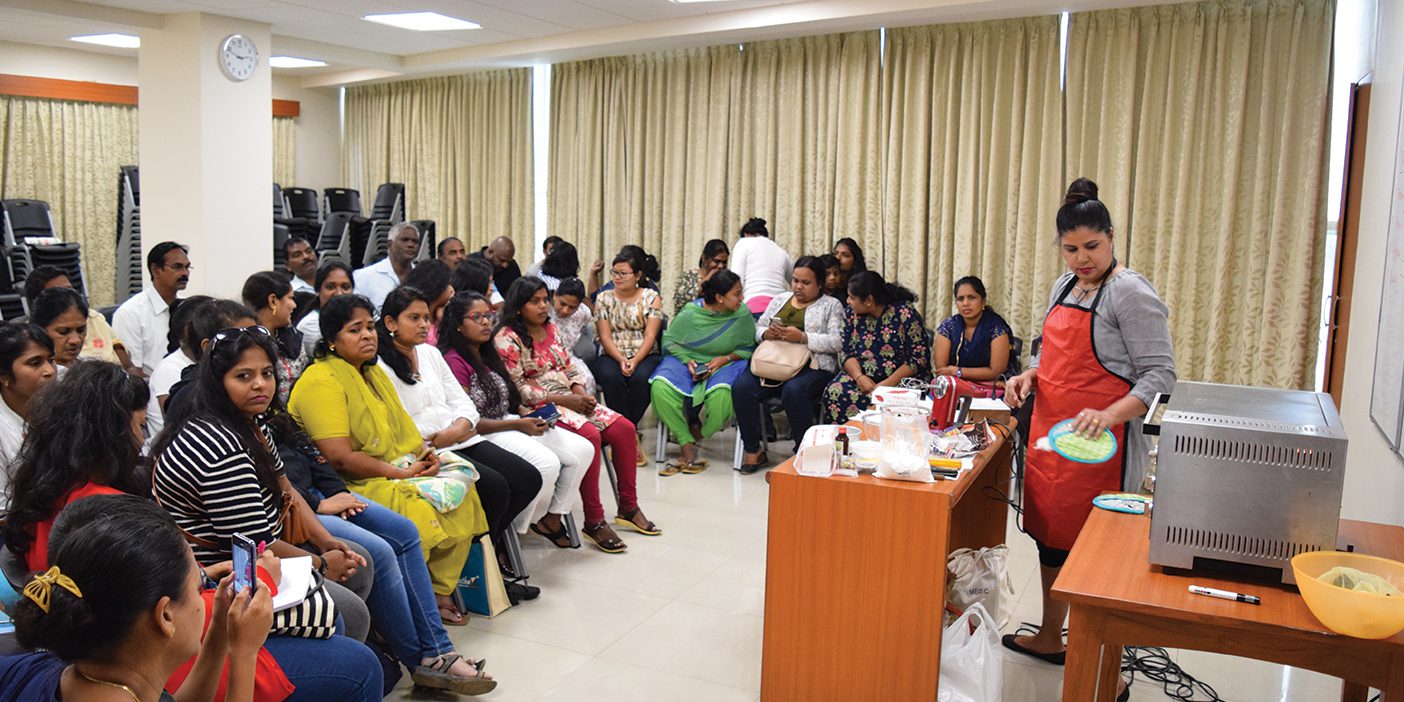 A photo of a cake-baking seminar put on by the BYU Management Society India Chapter.