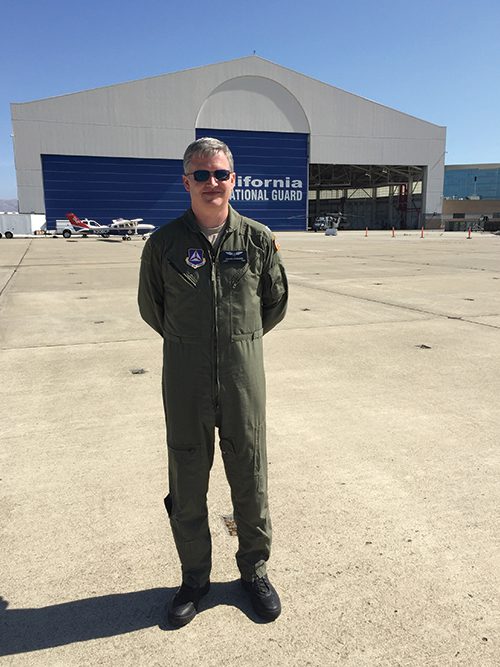 Joshua Edwards stands outside the hangar of the California National Guard.