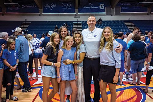 Coach Mark Pope with his wife and daughters.