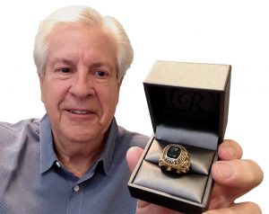 BYU grad Eric Paul holding the class ring returned to him after being lost for 50 years.