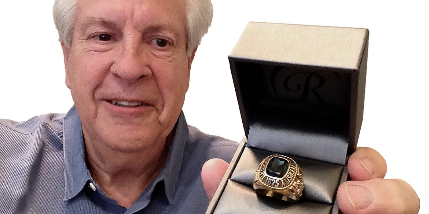 BYU grad Eric Paul holding the class ring returned to him after being lost for 50 years.