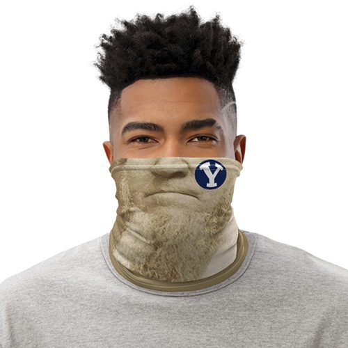 A photo illustration shows a man wearing a neck gaiter style mask with the nose, mouth, and busy beard of Brigham Young.