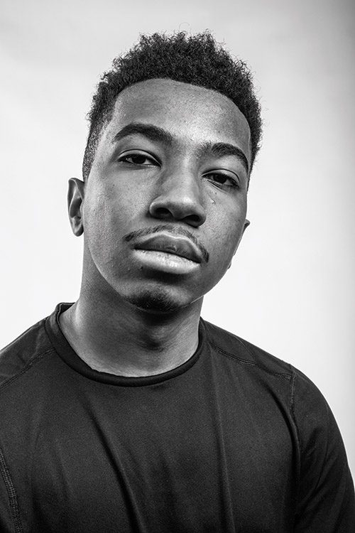 Black and white portrait of a Black, male student.