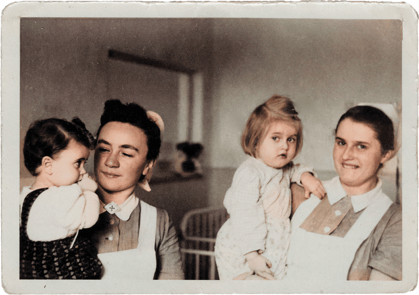 Erika Burton (right) holds a little girl alongside another nurse holding a child.