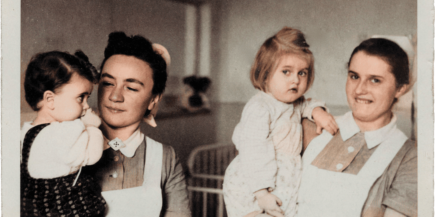 Erika Burton (right) holds a little girl alongside another nurse holding a child.