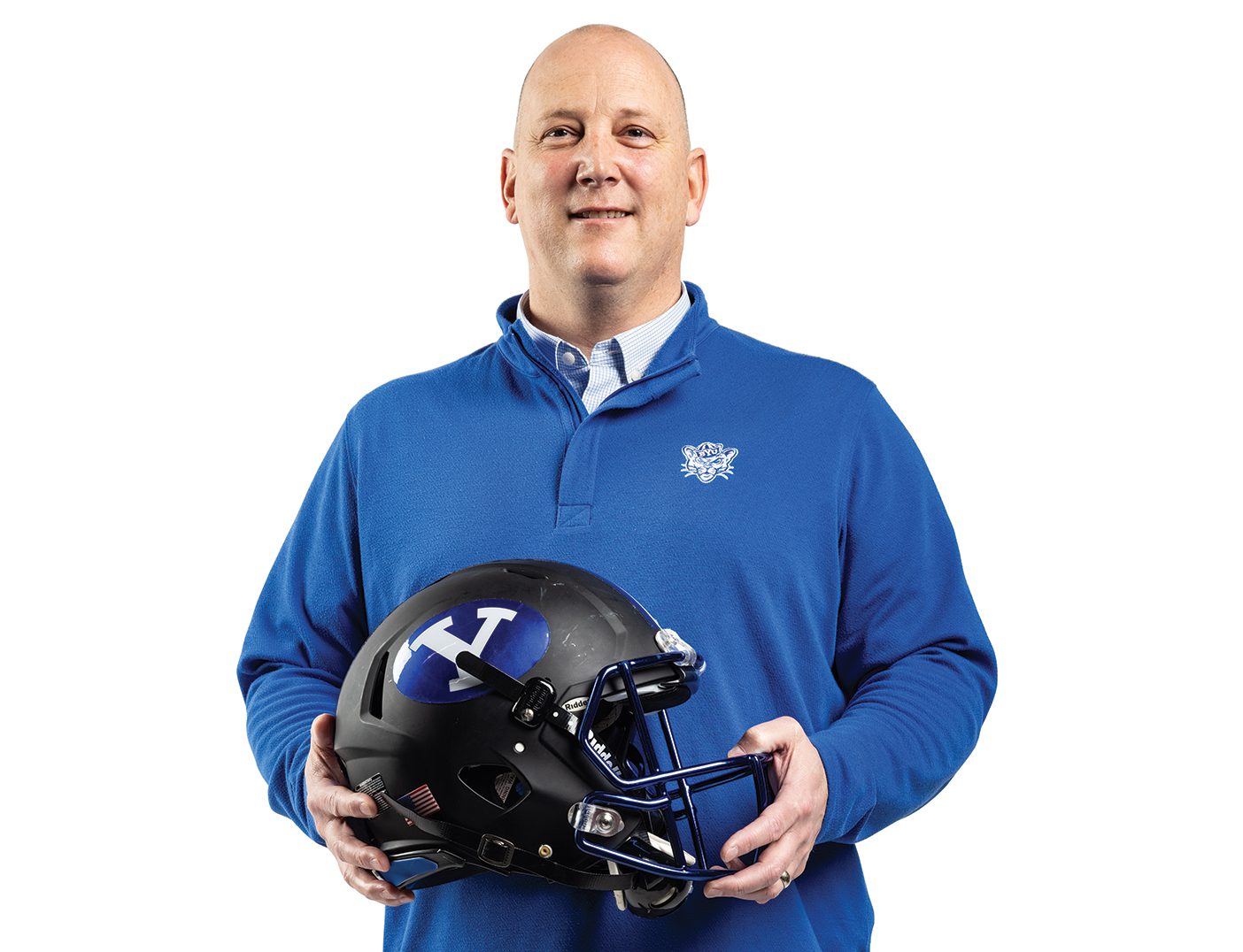 A man wearing a blue BYU sweatshirt holds a BYU football helmet.