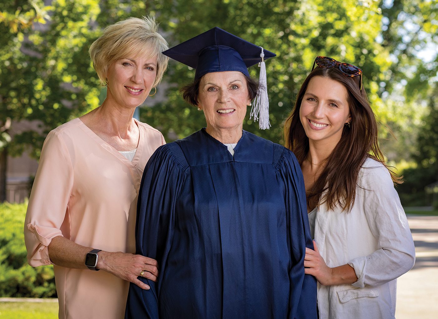 Erika Burton in a graduation gown with her daughter Sonja and granddaughter Alexa Jorgenson.