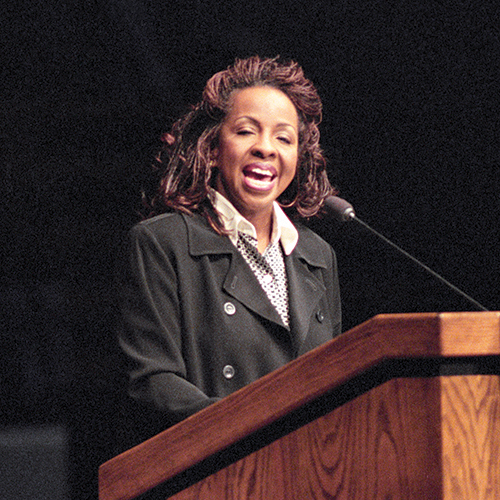 Gladys Knight stands at a pulpit.
