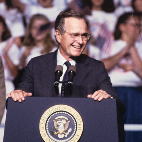 A photo of President Bush of the United States speaking at a podium.